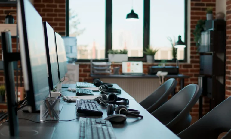 No people at desk with multiple computers in call center office